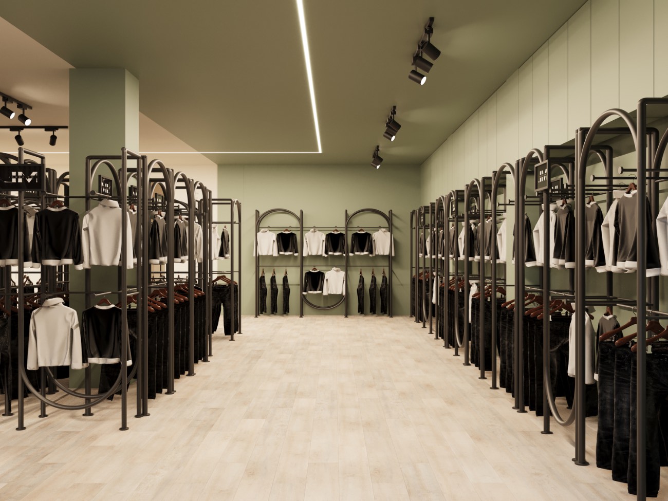 A sage-green aisle lined with arched black steel garment rails hung with denim and knitwear